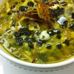 aash is a kind of soup with big noodles and beans and peas inside.