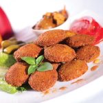 felafel a food from peas with decorations with vegetables and tomatos