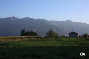 the photo shows a cottage in alamut valley located in high altitudes in hot summer time. 