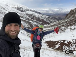 the photo shows a man and a woman while trekking in alborz ranges. 