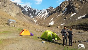the photo shows a couple which is camping in alamut valley